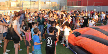 Niños y jóvenes de Villares saltan al campo de fútbol para adentrarse en el castillo hinchable gigante