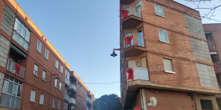 Un centenar de lazos rojos de gran formato lucen en los balcones de Santa Marta