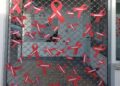 40 lazos rojos con mensajes en la puerta de la sede de Cruz Roja Santa Marta invitan a reflexionar sobre el estigma social que aún sufren los enfermos de Sida
